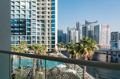 a view of a city with palm trees and buildings at Damac Maison Prive, Lake View - Free Parking in Dubai