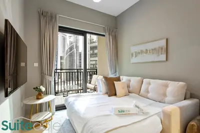 a living room with a bed and a balcony at Modern and Relaxing 1 Bedroom in Zada Tower in Dubai