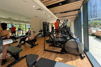 a gym with people exercising on tread machines in a building at Modern and Relaxing 1 Bedroom in Zada Tower in Dubai