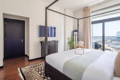 a bedroom with a large bed and a large window at Frank Porter - Green Lakes in Dubai
