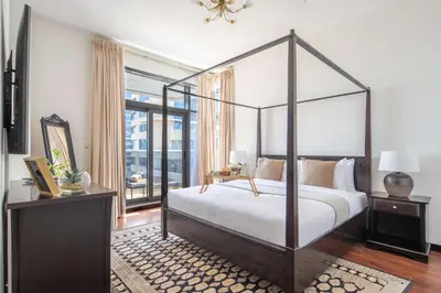 a bedroom with a canopy bed and a window at Frank Porter - Green Lakes in Dubai