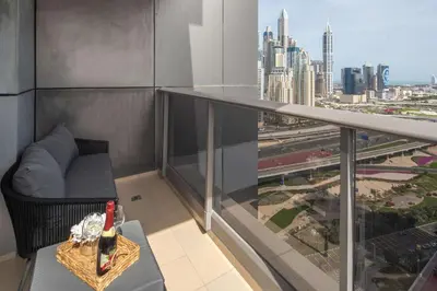 a balcony with a table with a bottle of wine at Frank Porter - Green Lakes in Dubai