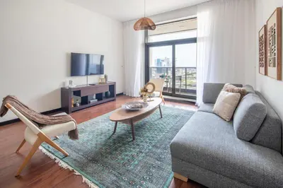a living room with a couch and a table at Frank Porter - Green Lakes in Dubai