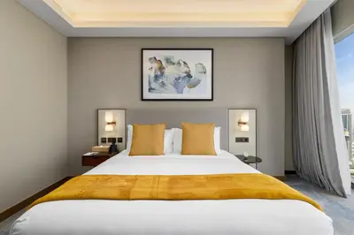 a bedroom with a large bed and a large window at Maison Privee - Exclusive Apt with Unmatched Burj Khalifa Views in Dubai