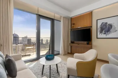 a living room with a view of a city at Maison Privee - Exclusive Apt with Unmatched Burj Khalifa Views in Dubai