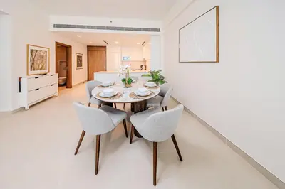 a dining room with a table and chairs at Brand new 1BD apartment in Canal Front Residence in Dubai