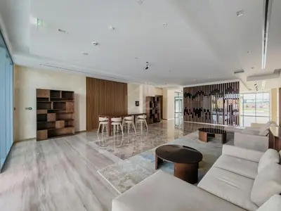 a living room with a couch and a table at Brand new 1BD apartment in Canal Front Residence in Dubai