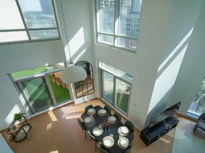 an overhead view of a living room with a table and windows at 3BR Loft I Burj Khalifa & Mall in Dubai