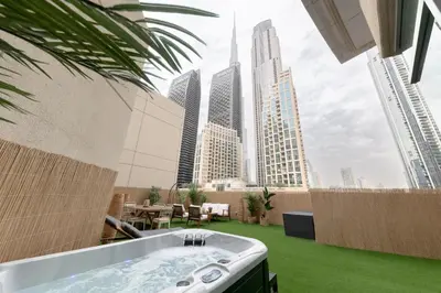 a hot tub on a rooftop with a view of the city at 3BR Loft I Burj Khalifa & Mall in Dubai