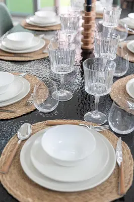a table with plates and wine glasses on it at 3BR Loft I Burj Khalifa & Mall in Dubai