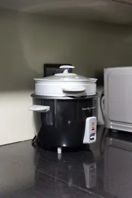 a pot on top of a counter next to a microwave at 3BR Loft I Burj Khalifa & Mall in Dubai
