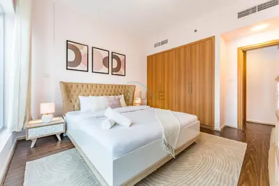 a bedroom with a large white bed in a room at Affordable Living 1BR, Steps from Retail Stores, Skycourts Tower D, Dubailand by Deluxe Holiday Homes in Dubai