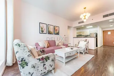 a living room with a couch and two chairs at Affordable Living 1BR, Steps from Retail Stores, Skycourts Tower D, Dubailand by Deluxe Holiday Homes in Dubai