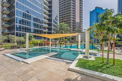 a swimming pool in a city with tall buildings at Downtown Retreat 1BR with Skyline Views & WiFi in Dubai