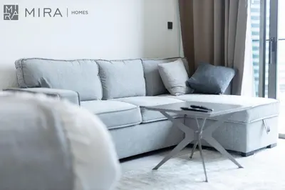 a living room with a couch and a table at Mira Holiday Homes - Bright studio with Burj Khalifa view in Business Bay in Dubai