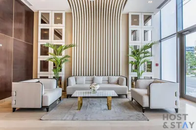 a living room with two couches and a coffee table at Elegant Studio Without Balcony- Damac Hills, Dubai - Host & Stay in Dubai