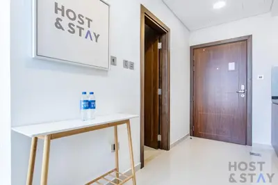 a room with a desk and a door at Elegant Studio Without Balcony- Damac Hills, Dubai - Host & Stay in Dubai