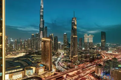 a view of a city at night with traffic at Glorious Burj Khalifa and Fountain views in Dubai