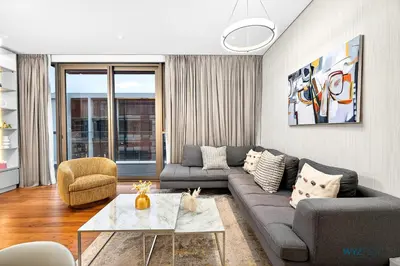 a living room with a couch and a table at Lush 2BR & Maids City Walk with Burj Khalifa View in Dubai