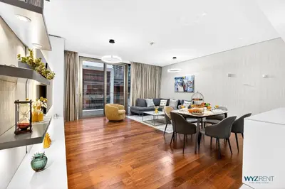 a living room and dining room with a table and chairs at Lush 2BR & Maids City Walk with Burj Khalifa View in Dubai