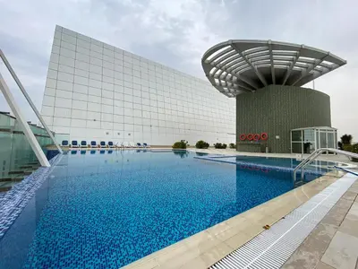 a swimming pool in front of a building at Full Lake View - 1BR Apartment in Goldcrest Views,Cluster V,JLT - Allsopp & Allsopp in Dubai