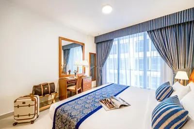 a hotel room with a bed and a large window at Golden Sands Bur Dubai in Dubai