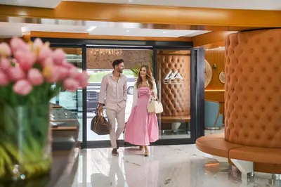 a man and a woman walking through a lobby at Golden Sands Bur Dubai in Dubai