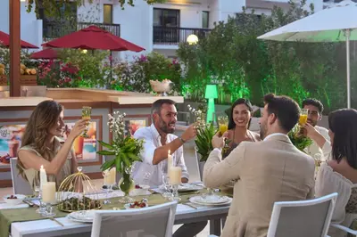 a group of people sitting around a table drinking champagne at Golden Sands Bur Dubai in Dubai