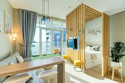 a bedroom with a bed and a tv in it at HiGuest - New! Stunning sea view studio, Balcony, Pool in Dubai