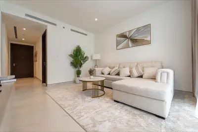 a living room with a couch and a table at Modern 1BR in Creek Vistas Grande, Burj Khalifa View in Dubai