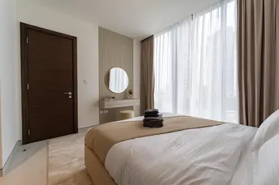 a bedroom with a large bed and a large window at Modern 1BR in Creek Vistas Grande, Burj Khalifa View in Dubai