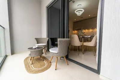 a dining room with a table and chairs and a mirror at Modern 1BR in Creek Vistas Grande, Burj Khalifa View in Dubai