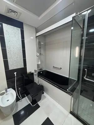 a bathroom with a shower and a toilet and a sink at 1 BR in Mall St in Dubai