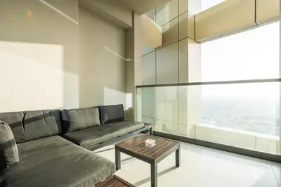 a living room with a couch and a table at Elegant Sunset View 3BHK 7pax in Dubai
