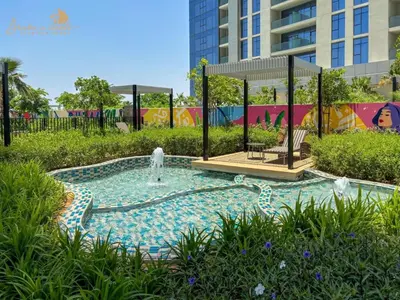 a swimming pool with a fountain in a park at Elegant Sunset View 3BHK 7pax in Dubai