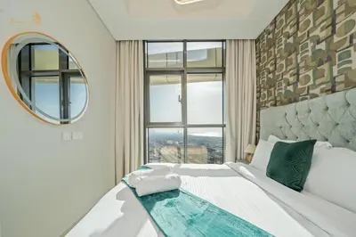a bedroom with a bed with a swimming pool on it at Elegant Sunset View 3BHK 7pax in Dubai