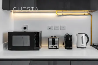 a kitchen counter with a microwave and other appliances on it at Terraces Marasi Drive, Business Bay in Dubai
