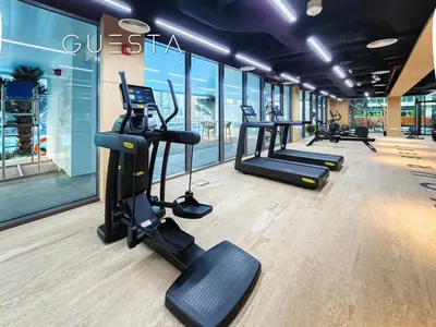 a gym with treadmills and elliptical machines at Terraces Marasi Drive, Business Bay in Dubai