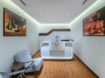 a living room with a couch and a chair at Terraces Marasi Drive, Business Bay in Dubai
