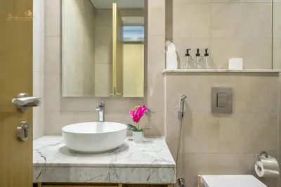 a bathroom with a sink and a mirror at Classic Canal View 2 Bhk 6pax in Dubai
