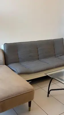 a couch and a table in a living room at Royal bay Azizi Palm Jumeirah in Dubai