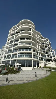 a large white building with a lot of windows at Royal bay Azizi Palm Jumeirah in Dubai