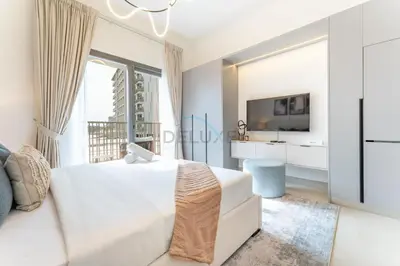 a bedroom with a white bed and a large window at Community Views Studio Near Nad Al Sheba Gardens with Balcony, MAG 980, Mohammad Bin Rashid by Deluxe Holiday Homes in Dubai
