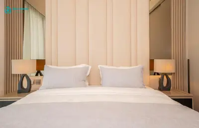 a bedroom with a white bed with two lamps at Blue Breeze - Luxury Apartment in Downtown in Dubai