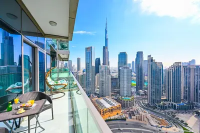 a balcony with a view of a city at New Luxury 2 Bedroom with Burj Khalifa View & Spectacular Rooftop Infinity Pool Bar in Dubai