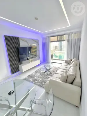 a living room with a white couch and a tv at BRAND NEW luxury & modern in JLT in Dubai