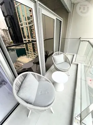 a room with two chairs and a table and a window at BRAND NEW luxury & modern in JLT in Dubai