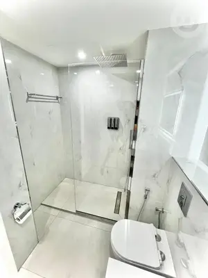 a white bathroom with a shower and a toilet at BRAND NEW luxury & modern in JLT in Dubai