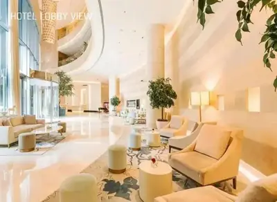a large living room with couches and chairs in a building at JW Marriot Hotel Residence - Two bedroom Suite in Dubai