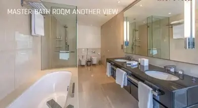a bathroom with two sinks and a large mirror at JW Marriot Hotel Residence - Two bedroom Suite in Dubai
